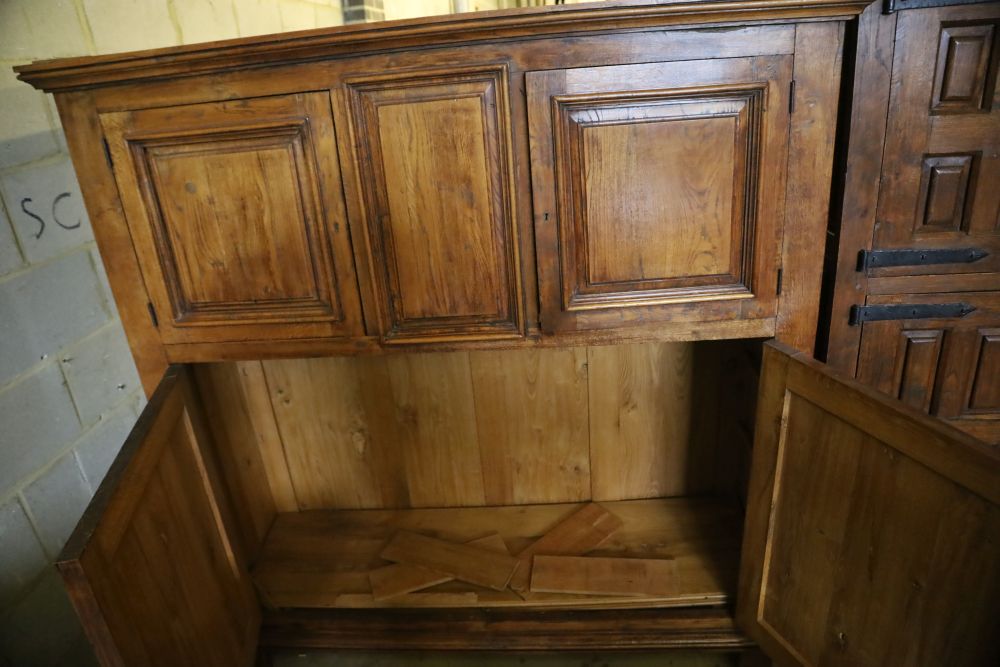 A 19th century French panelled walnut press cupboard fitted upper and lower pairs of doors, width 172cm, depth 52cm, height 181cm